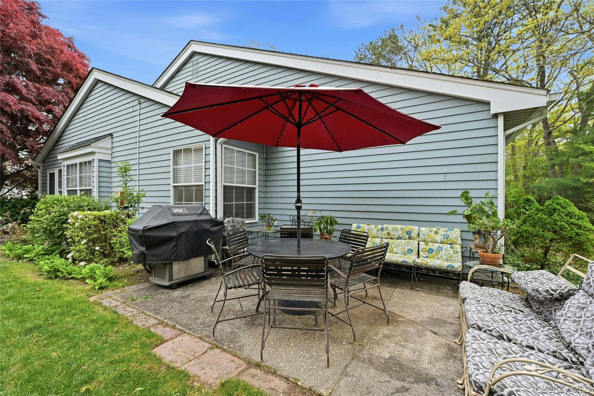 9 Baldwin Court, Unit 9 Ridge, NY 11961 - Photo 26 of 27 a view of backyard with outdoor seating and plants