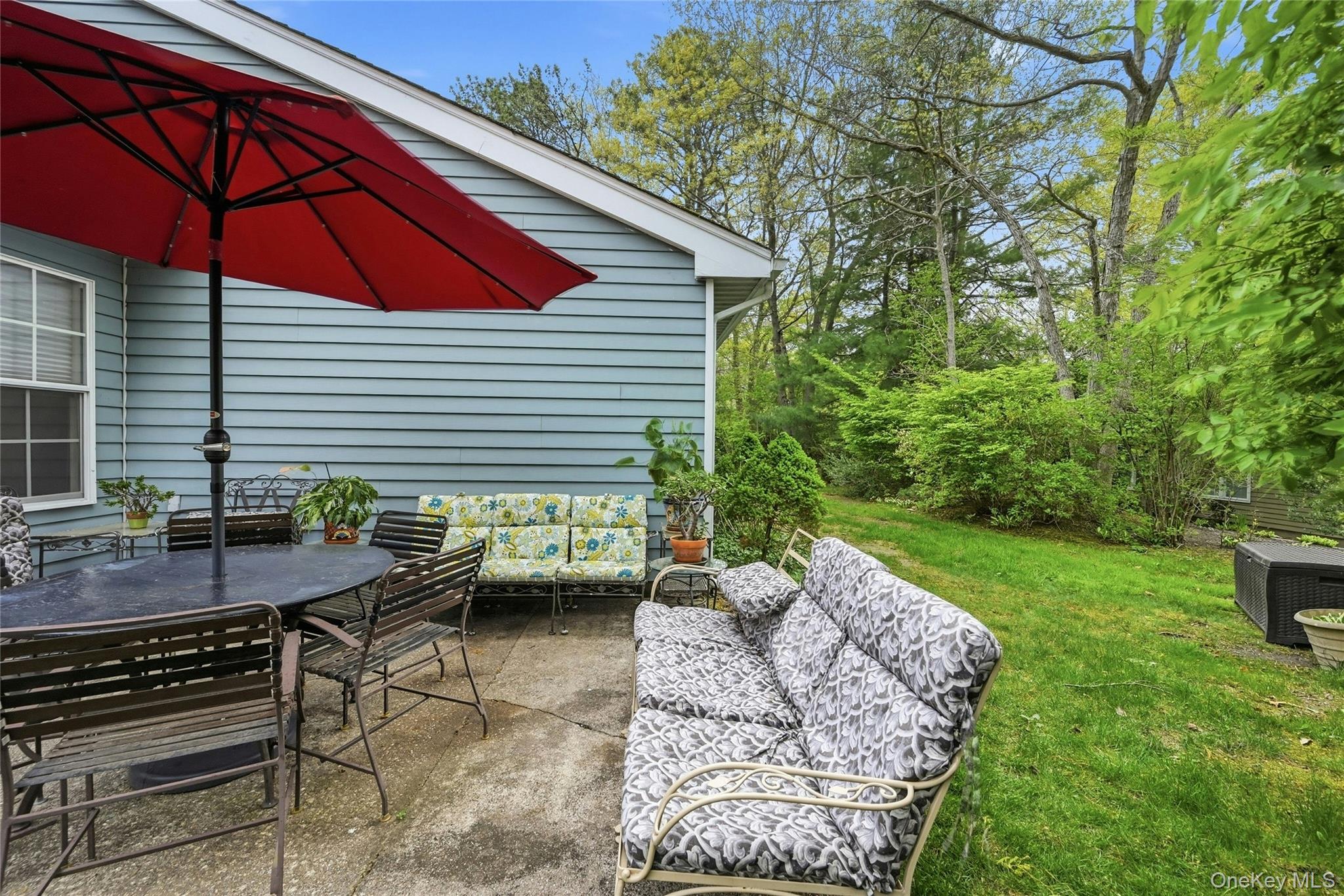 9 Baldwin Court, Unit 9 Ridge, NY 11961 - Photo 27 of 27 a view of backyard with outdoor seating