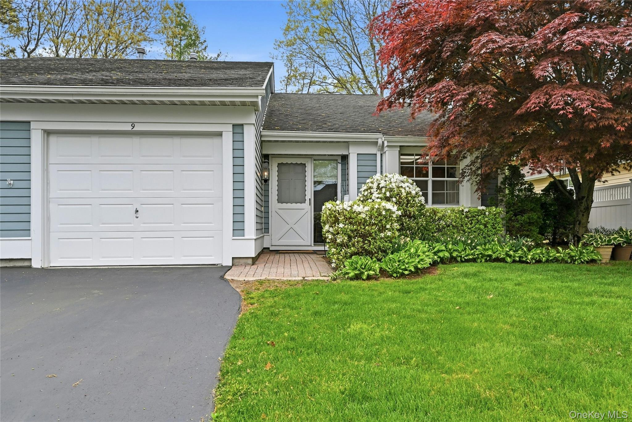 9 Baldwin Court, Unit 9 Ridge, NY 11961 - Photo 3 of 27 front view of a house with a yard