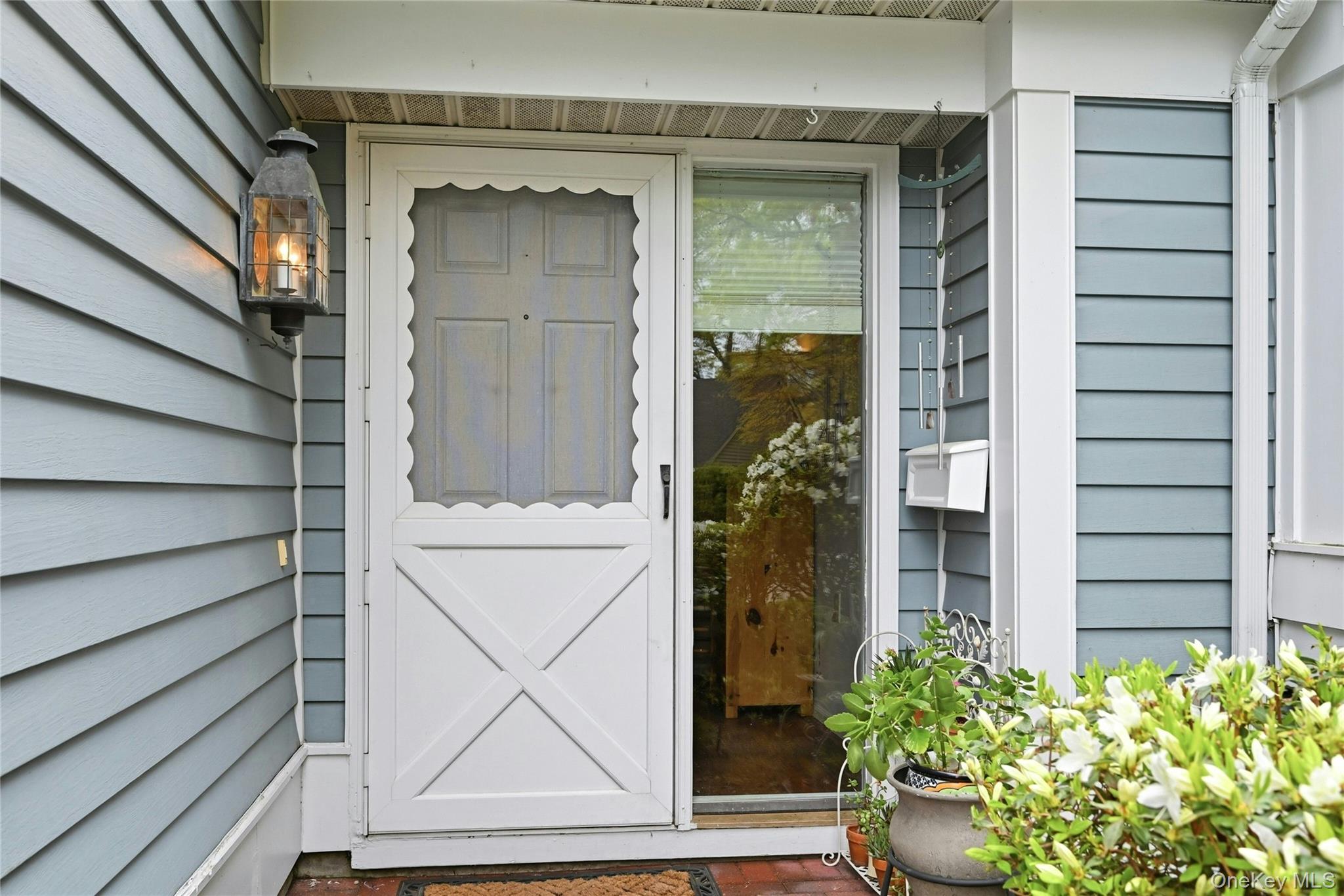 9 Baldwin Court, Unit 9 Ridge, NY 11961 - Photo 4 of 27 a view of front door and potted plants