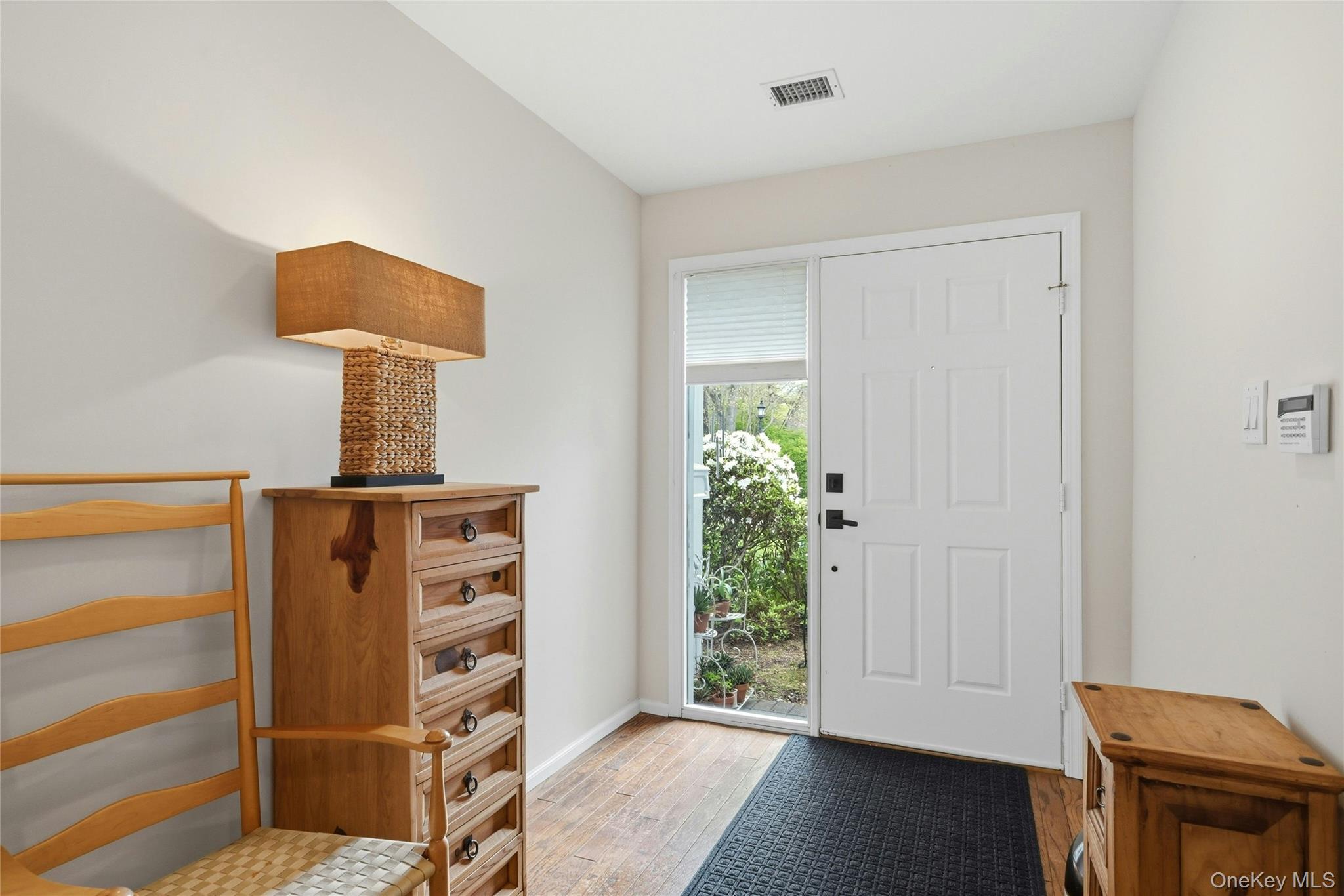 9 Baldwin Court, Unit 9 Ridge, NY 11961 - Photo 5 of 27 a view of a room with wooden floor and cabinet