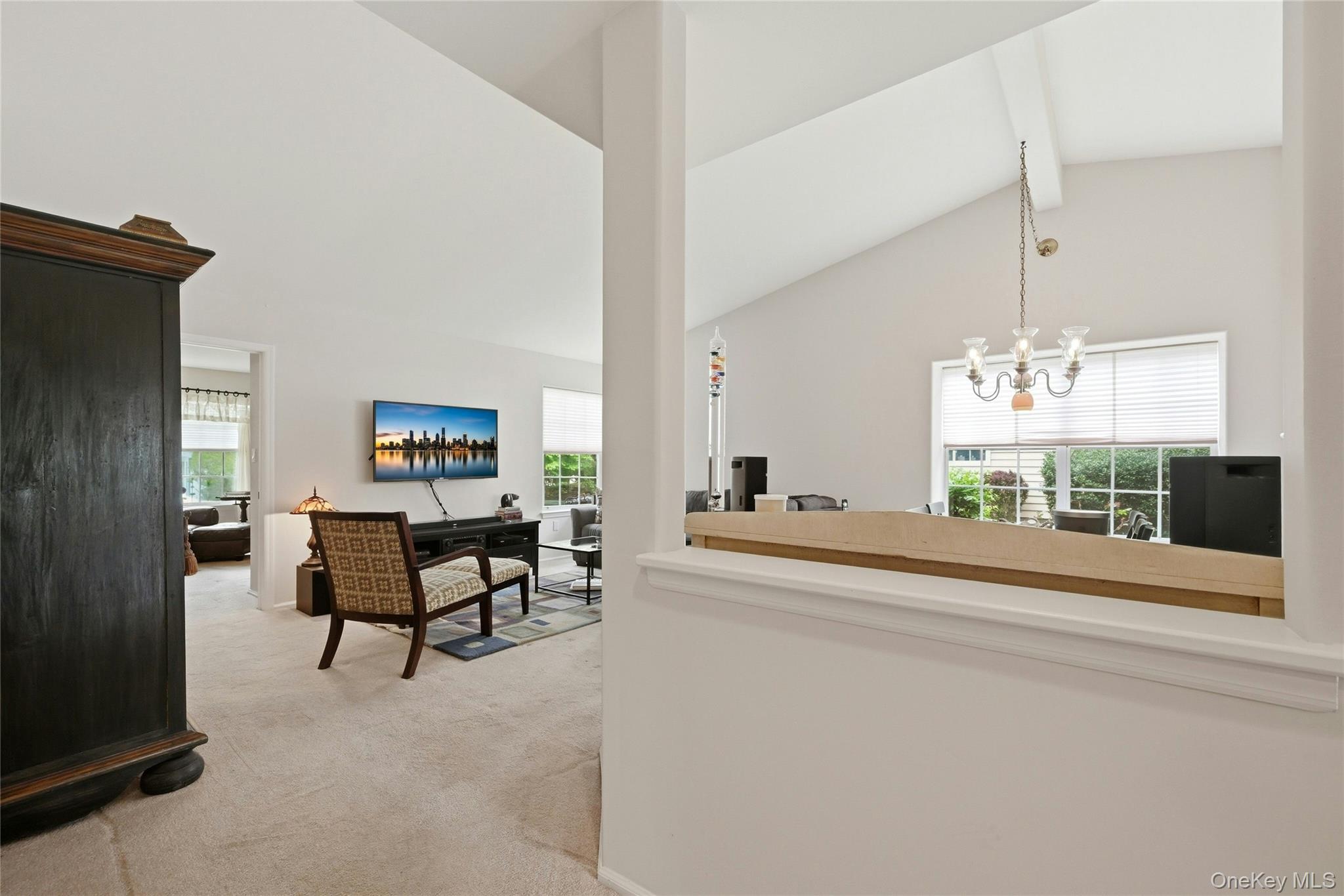9 Baldwin Court, Unit 9 Ridge, NY 11961 - Photo 6 of 27 a view of a livingroom with furniture wooden floor and a chandelier