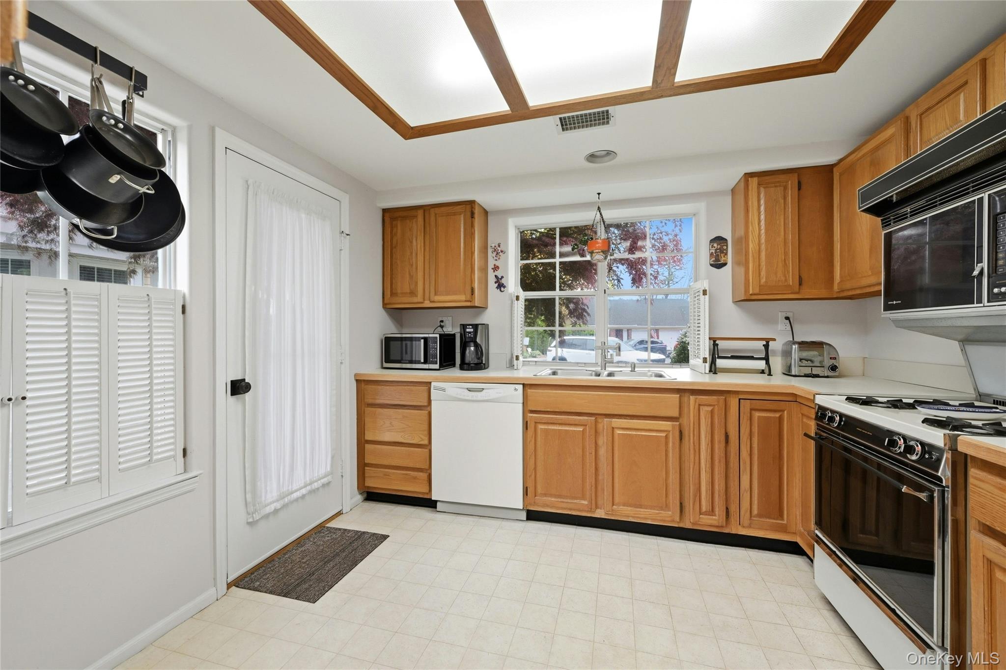 9 Baldwin Court, Unit 9 Ridge, NY 11961 - Photo 9 of 27 a kitchen with stainless steel appliances granite countertop a stove and a sink