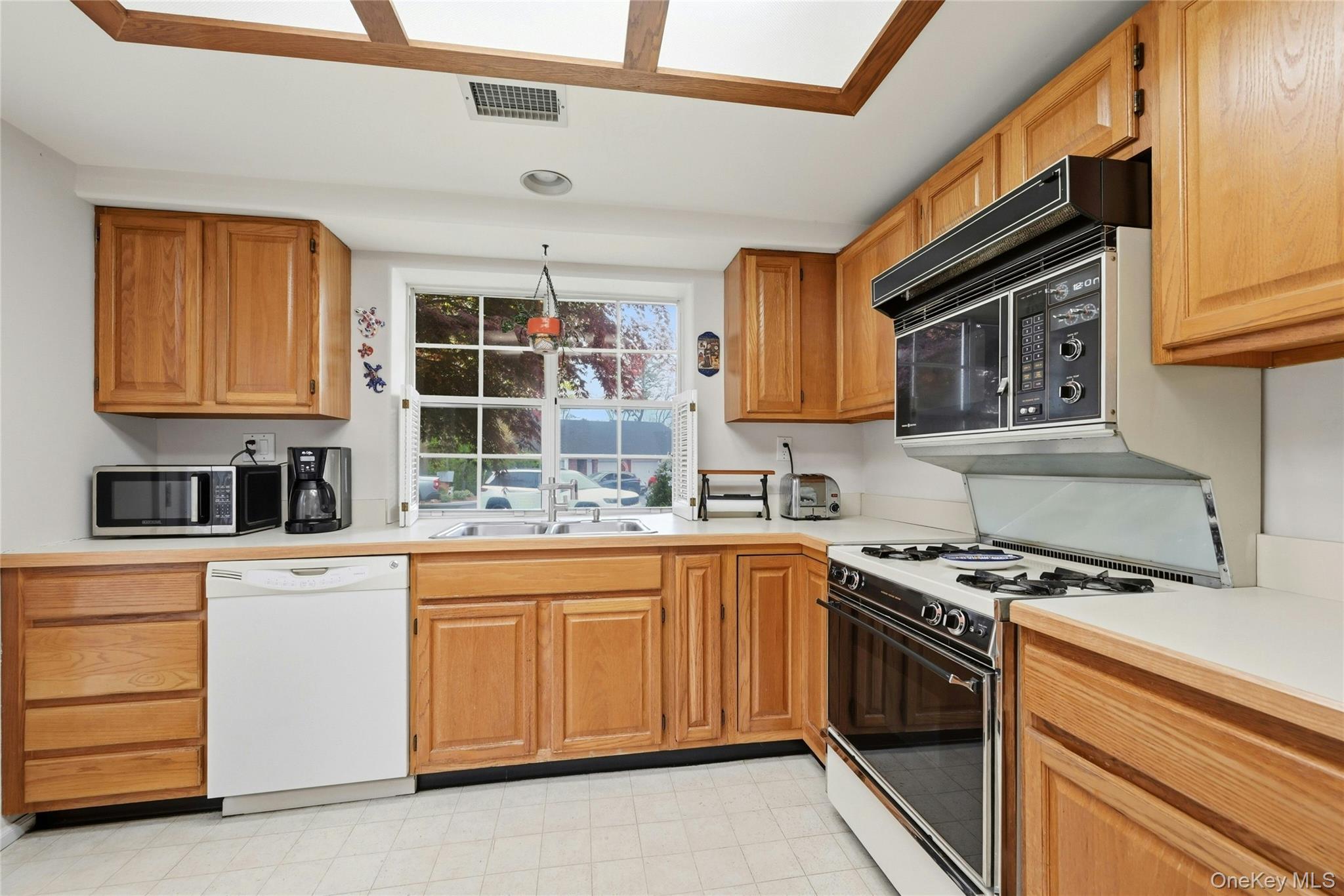 9 Baldwin Court, Unit 9 Ridge, NY 11961 - Photo 10 of 27 a kitchen with stainless steel appliances granite countertop a stove and a sink