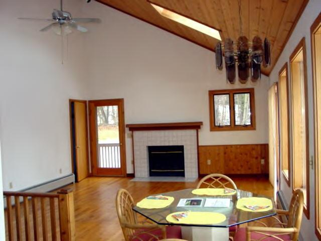 47 Dean Hill Road Richmond, MA 01254 - Photo 3 of 7 a room with wooden floor table and a fireplace