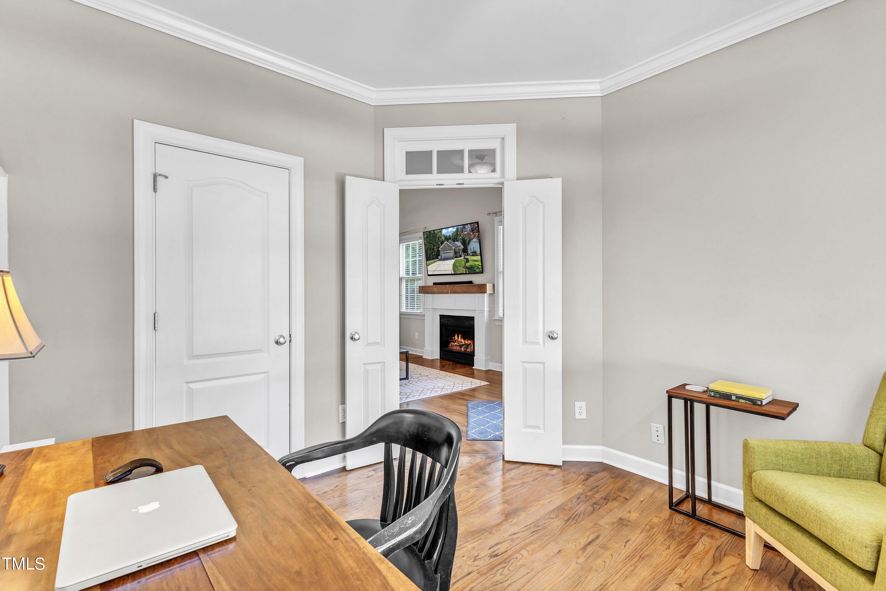 6323 Cedar Waters Drive Raleigh, NC 27607 - Photo 15 of 84 a view of a workspace with furniture and wooden floor