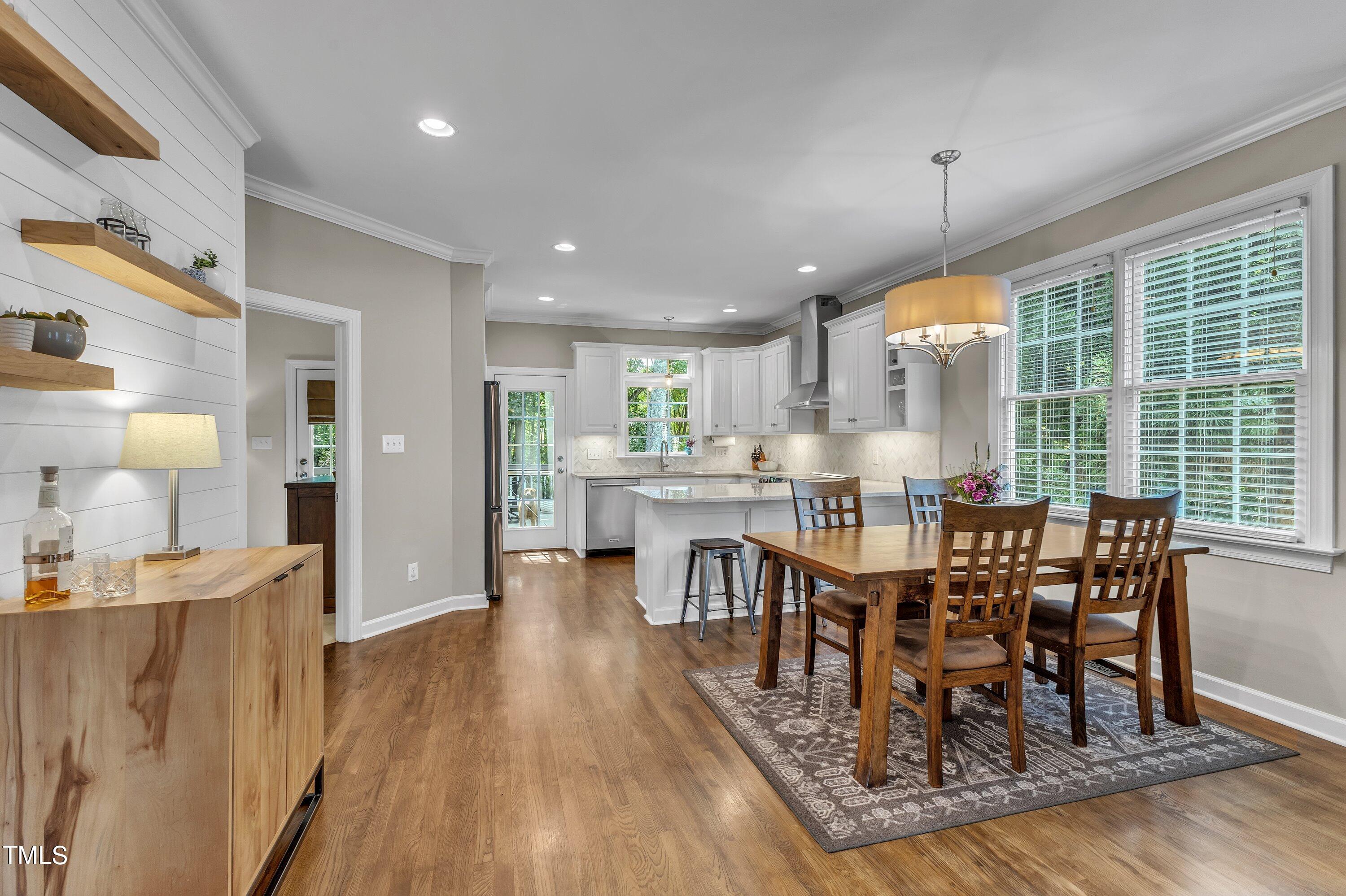 6323 Cedar Waters Drive Raleigh, NC 27607 - Photo 18 of 84 a view of a dining room with furniture window and wooden floor