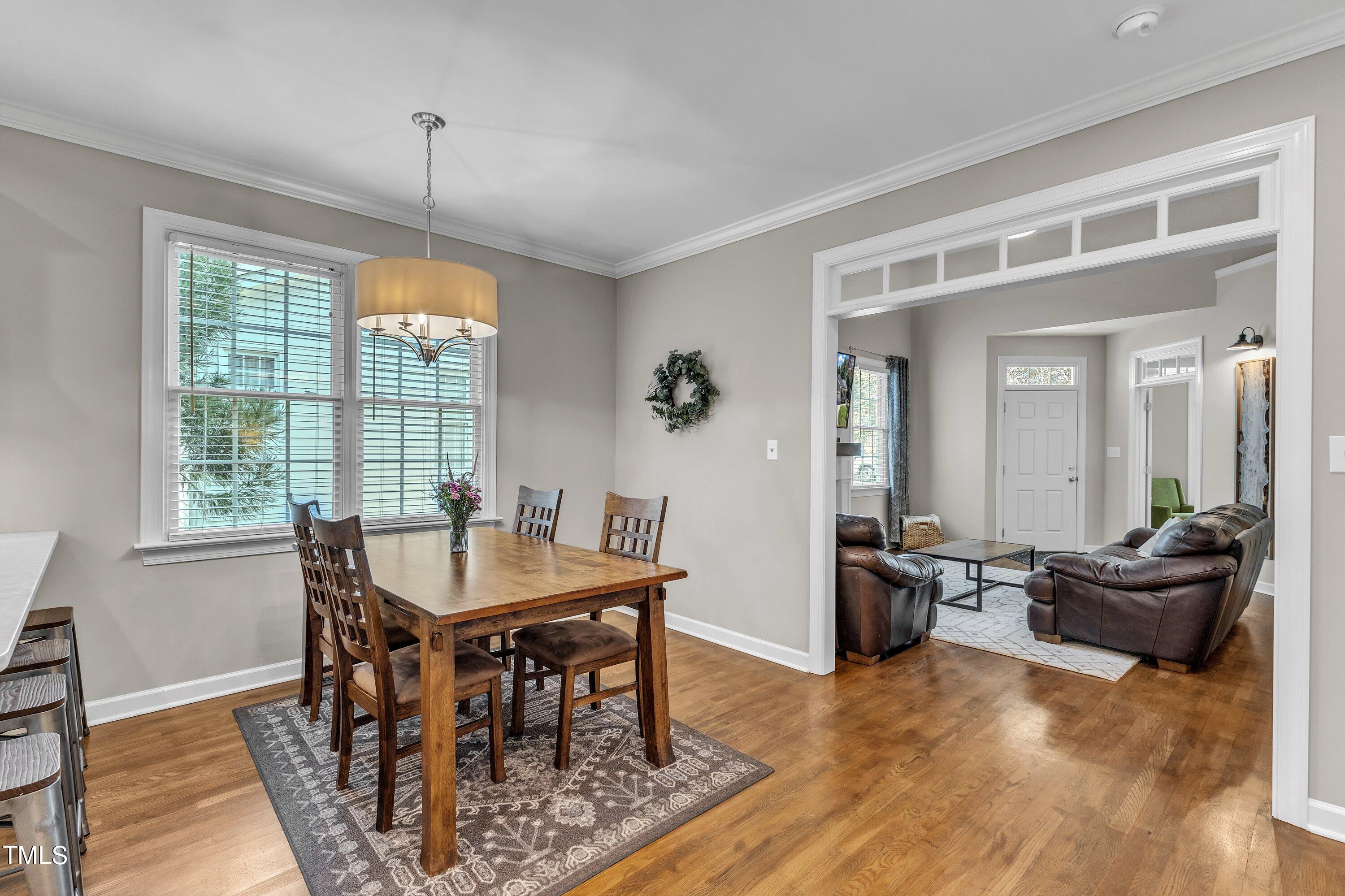 6323 Cedar Waters Drive Raleigh, NC 27607 - Photo 19 of 84 a view of a dining room with furniture window and wooden floor
