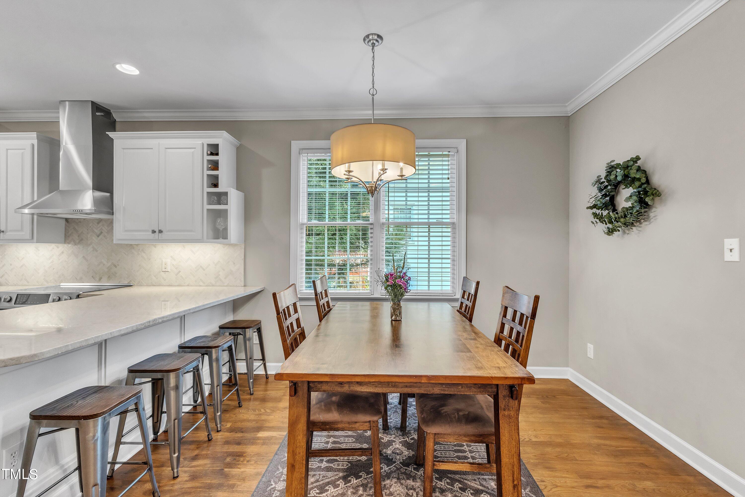 6323 Cedar Waters Drive Raleigh, NC 27607 - Photo 21 of 84 a view of a dining room with furniture window and wooden floor