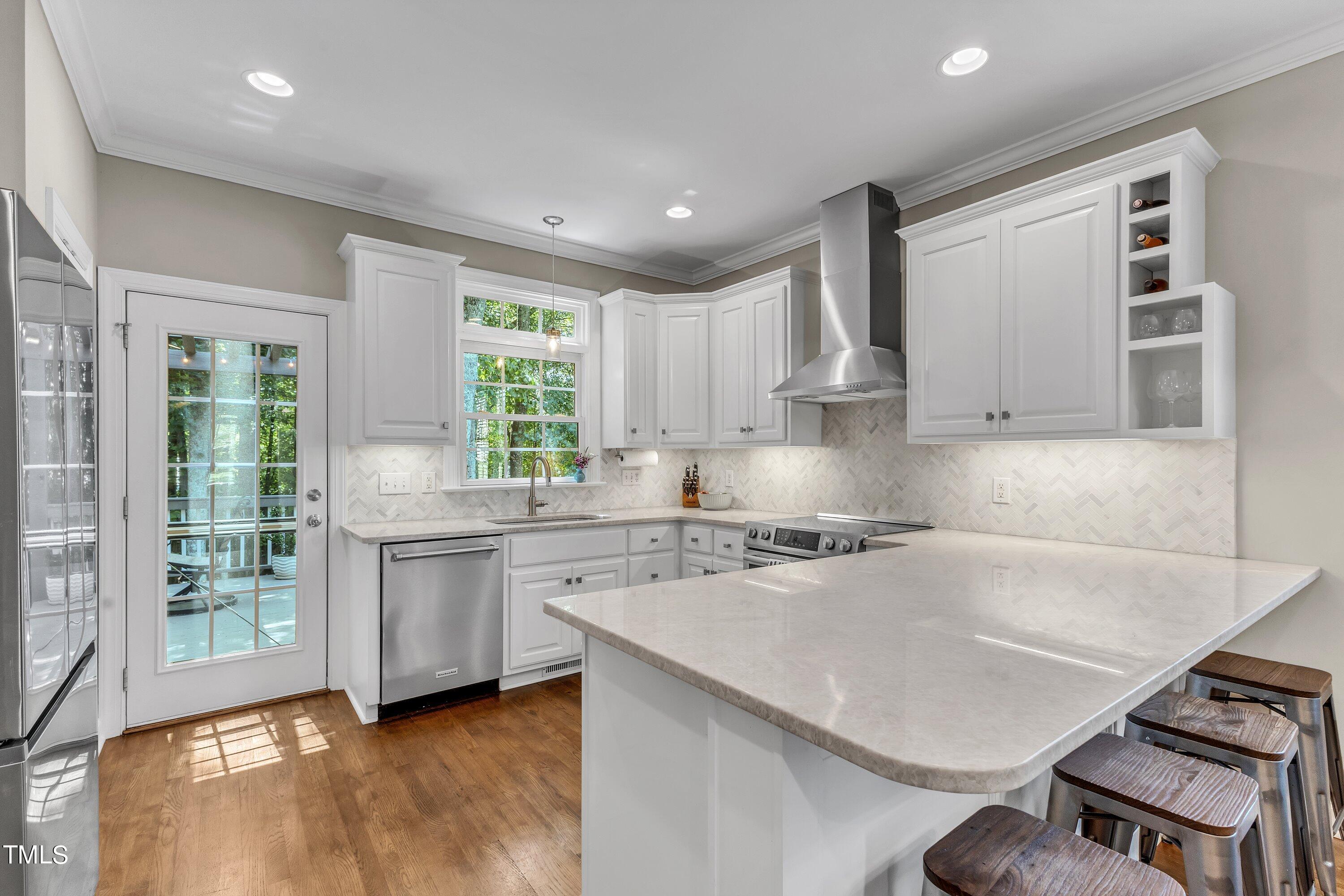 6323 Cedar Waters Drive Raleigh, NC 27607 - Photo 23 of 84 a kitchen with stainless steel appliances granite countertop a sink stove and refrigerator