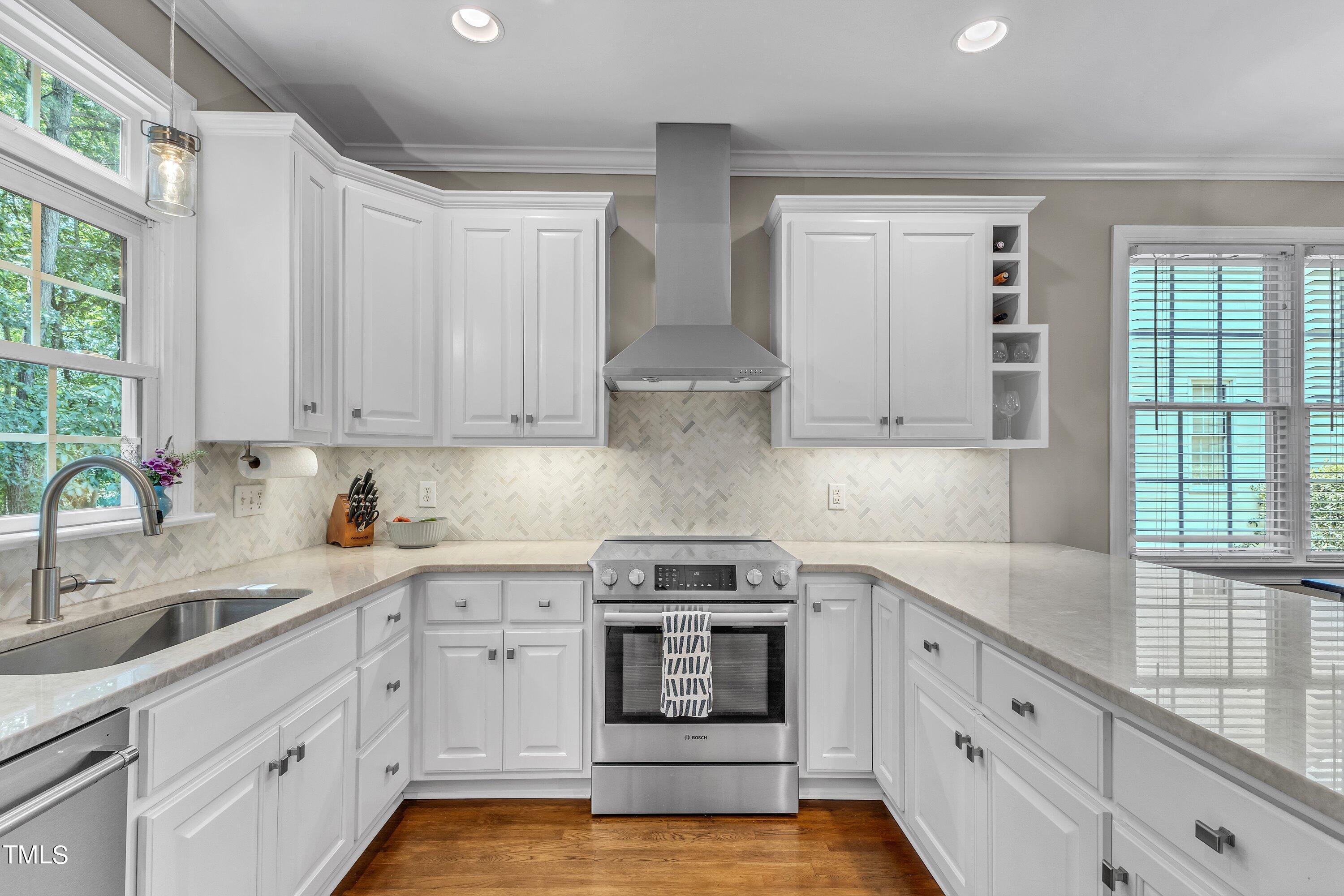 6323 Cedar Waters Drive Raleigh, NC 27607 - Photo 25 of 84 a kitchen with granite countertop white cabinets and white stainless steel appliances