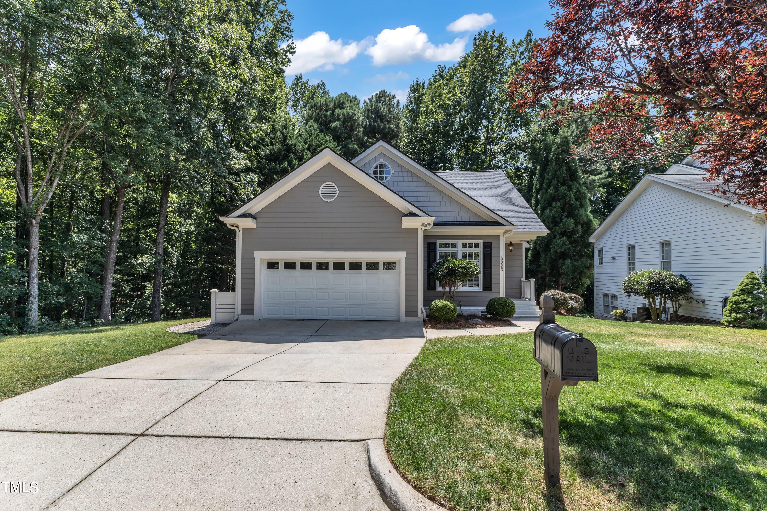 6323 Cedar Waters Drive Raleigh, NC 27607 - Photo 3 of 84 a view of a house with a yard potted plants and a large tree