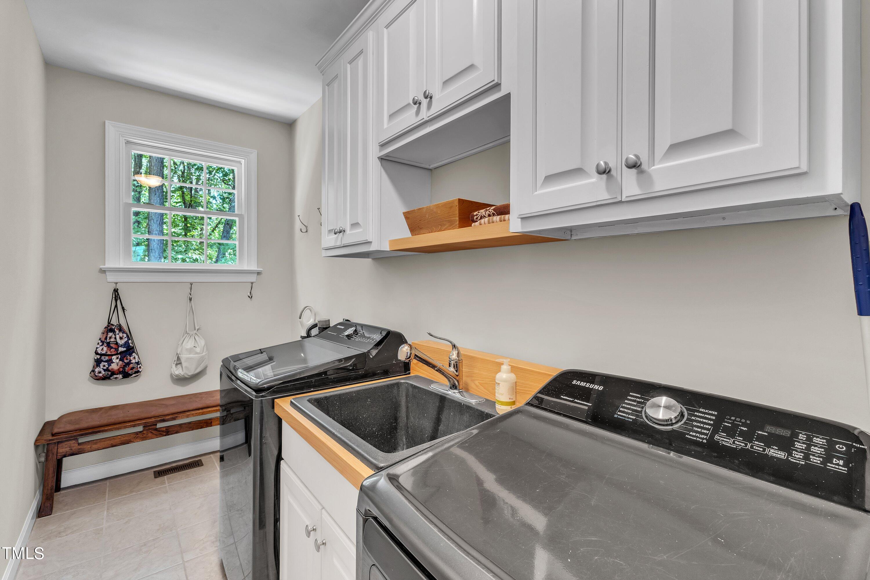 6323 Cedar Waters Drive Raleigh, NC 27607 - Photo 31 of 84 a kitchen with a cabinets and a stove top oven
