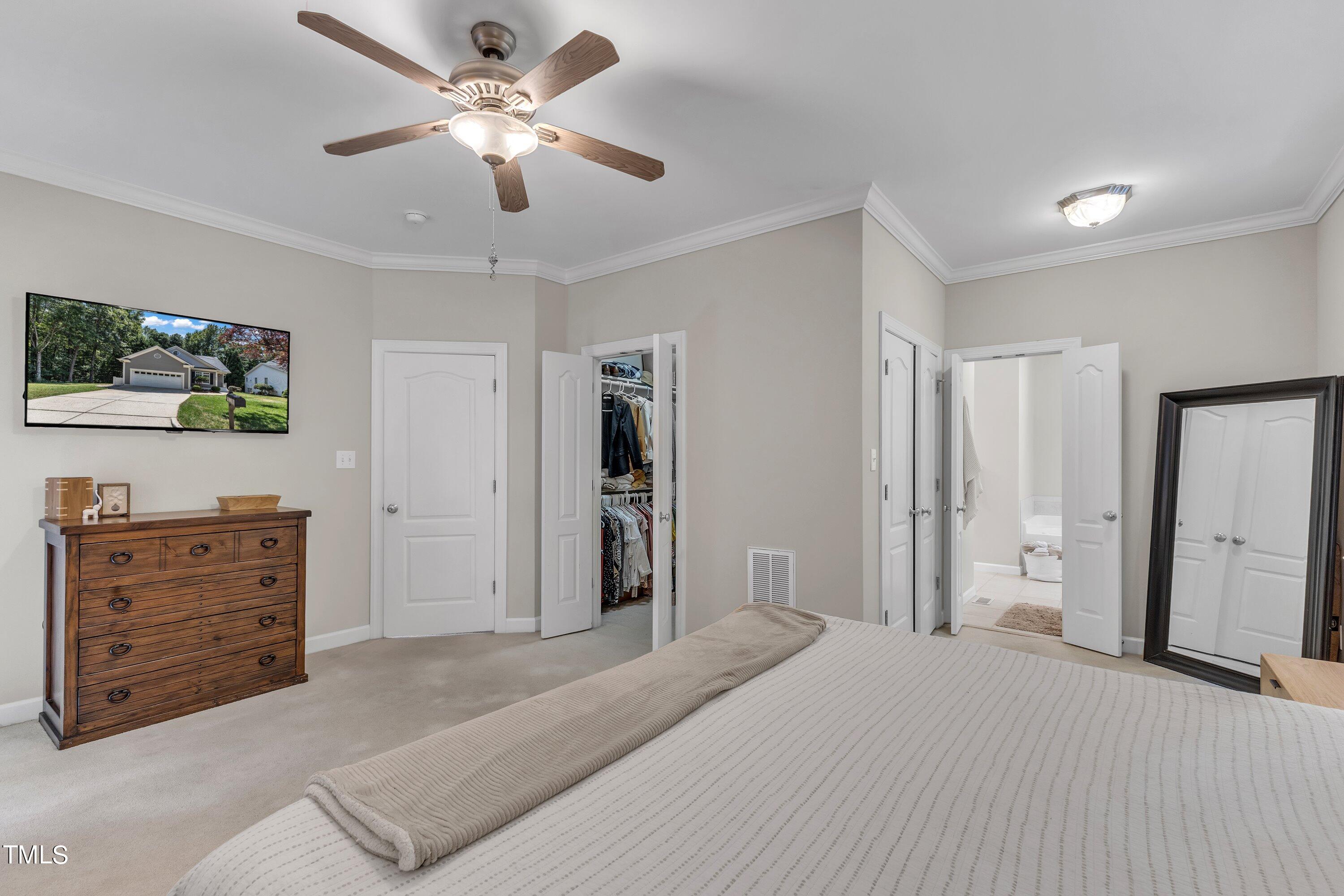 6323 Cedar Waters Drive Raleigh, NC 27607 - Photo 34 of 84 a bedroom with a bed and a flat screen tv