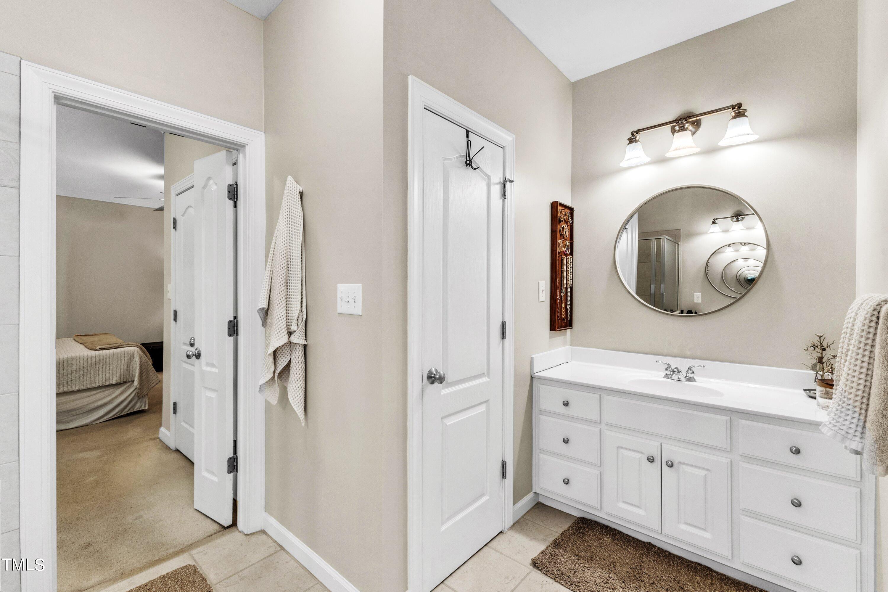 6323 Cedar Waters Drive Raleigh, NC 27607 - Photo 38 of 84 a bathroom with a double vanity sink mirror and shower