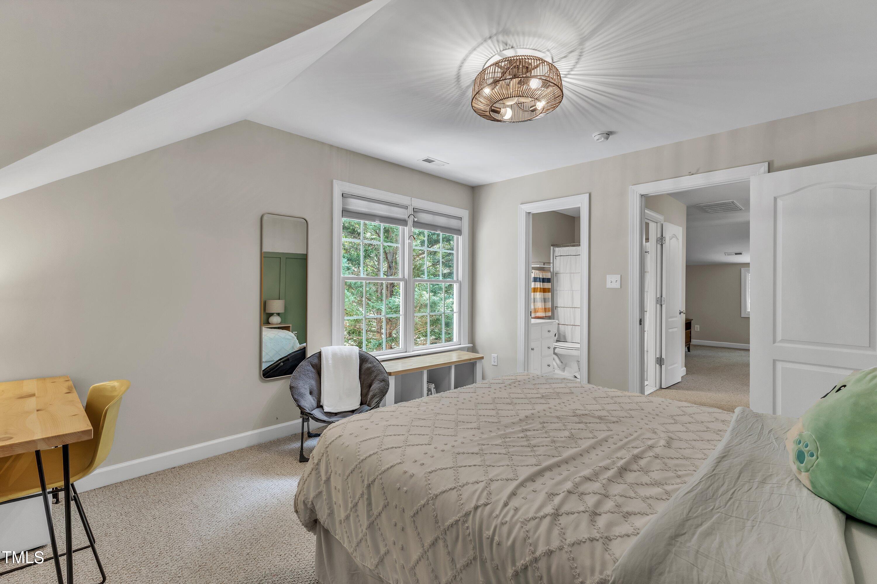 6323 Cedar Waters Drive Raleigh, NC 27607 - Photo 53 of 84 a bedroom with a bed and a chair