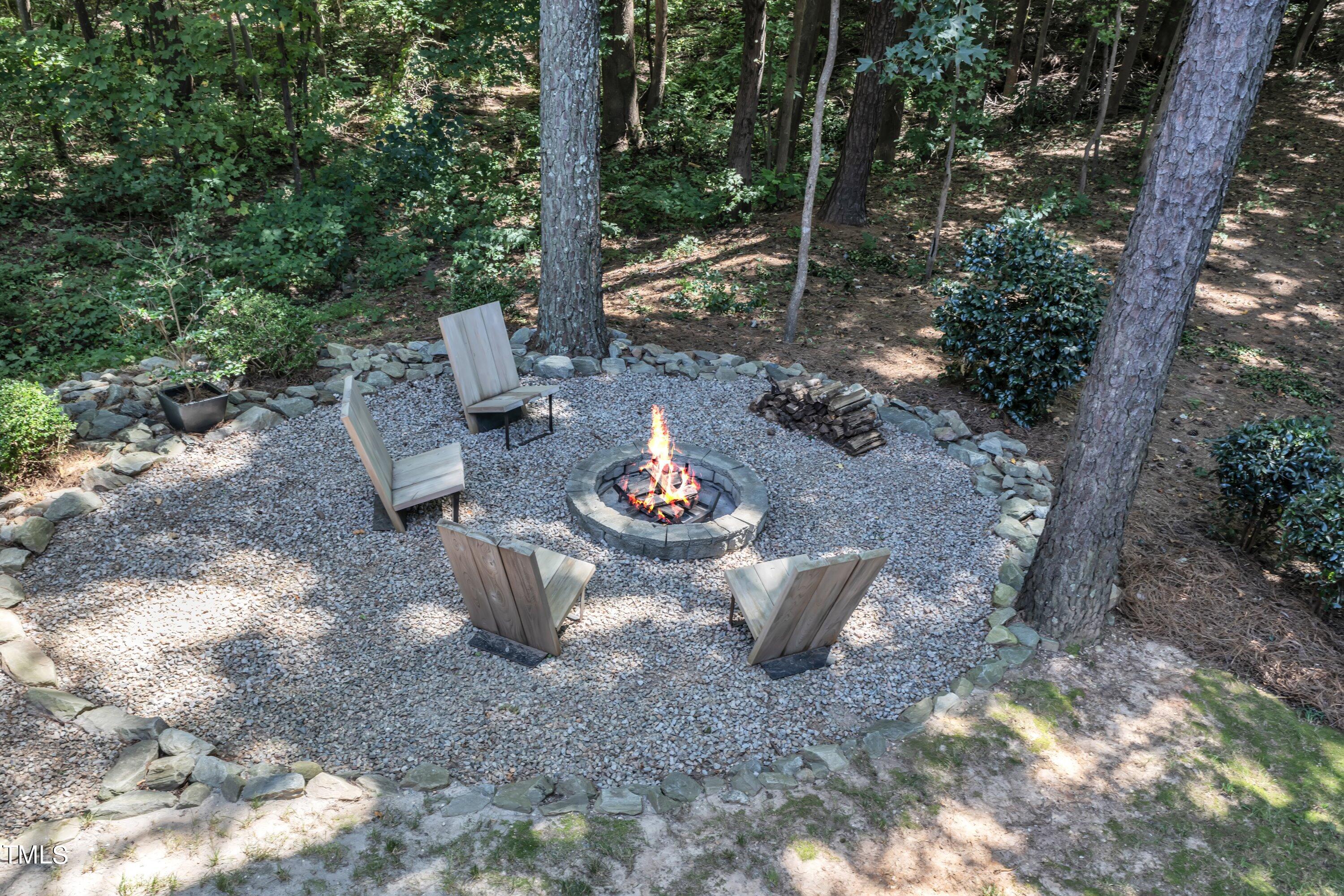 6323 Cedar Waters Drive Raleigh, NC 27607 - Photo 67 of 84 a view of a backyard with table and chairs potted plants and large tree