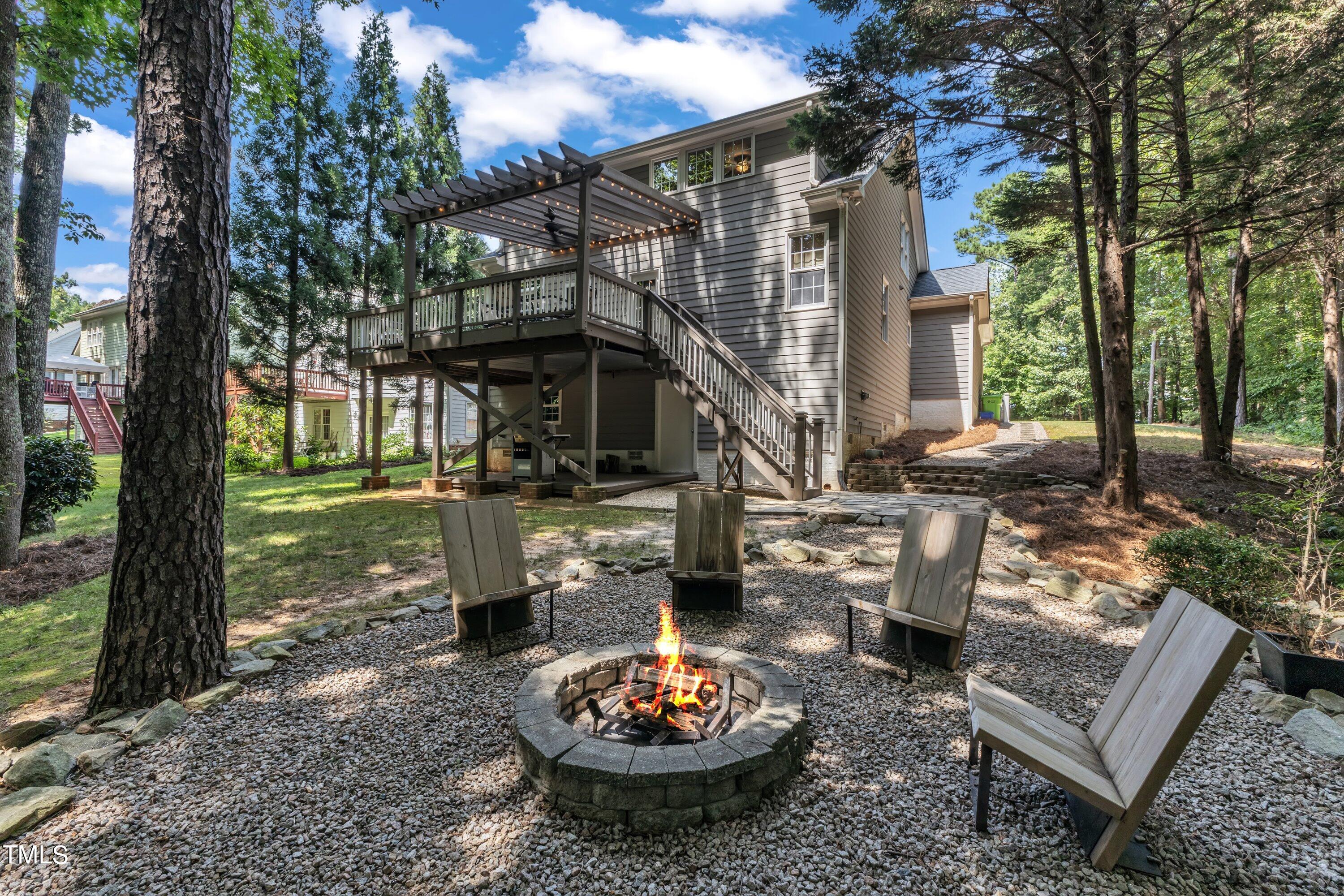 6323 Cedar Waters Drive Raleigh, NC 27607 - Photo 70 of 84 a view of a patio with a table chairs and a fire pit