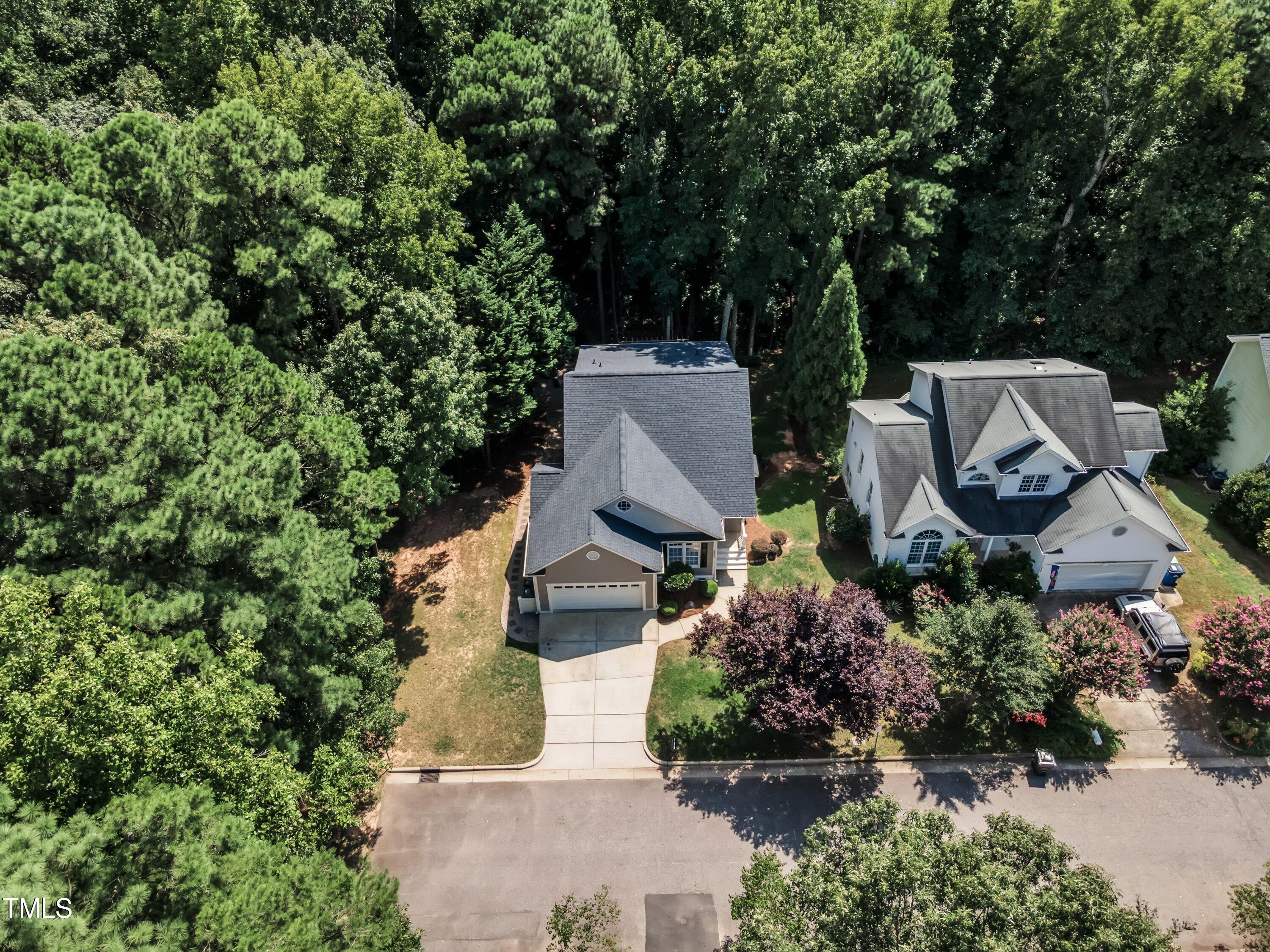 6323 Cedar Waters Drive Raleigh, NC 27607 - Photo 75 of 84 an aerial view of a house with a garden