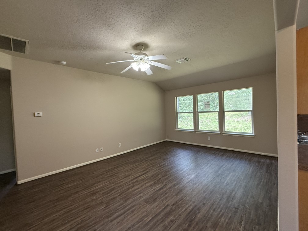 12595 Royal Springs Road Conroe, TX 77303 - Photo 13 of 26 a view of empty room with wooden floor and fan