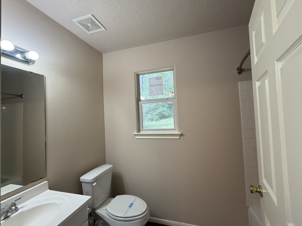 12595 Royal Springs Road Conroe, TX 77303 - Photo 16 of 26 a white toilet sitting next to a bathroom sink
