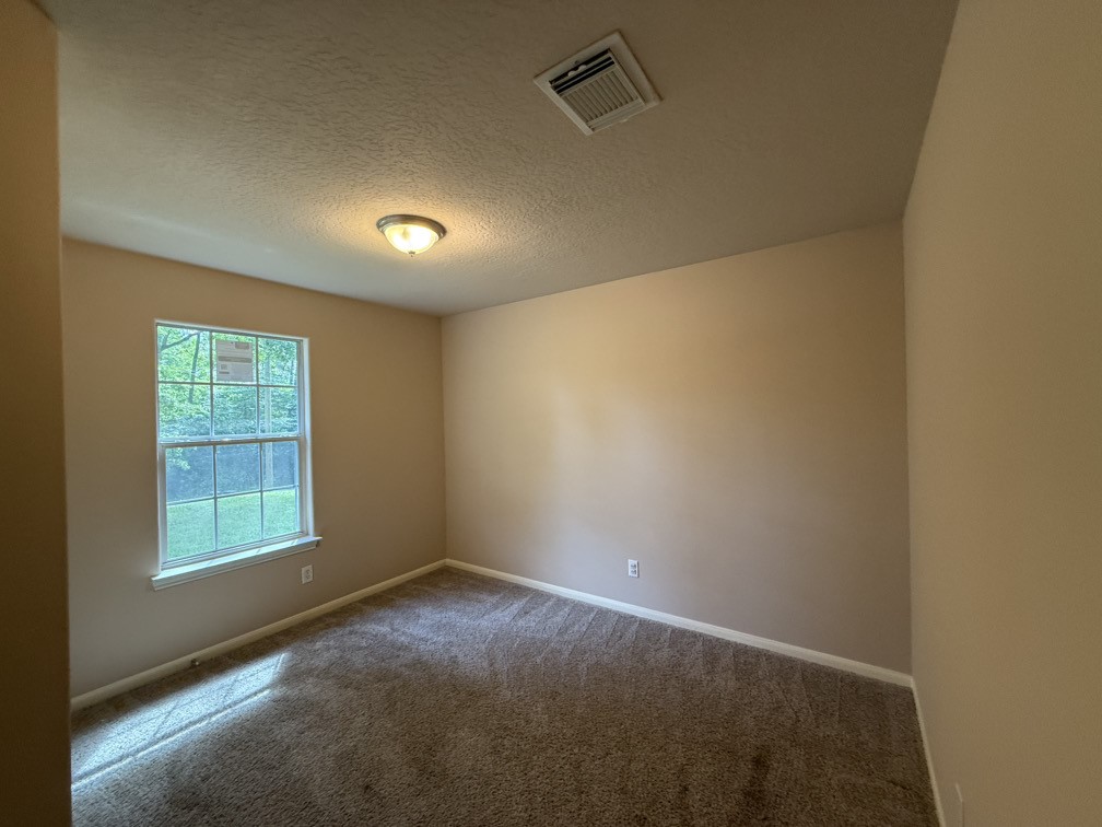 12595 Royal Springs Road Conroe, TX 77303 - Photo 22 of 26 an empty room with a empty space and windows