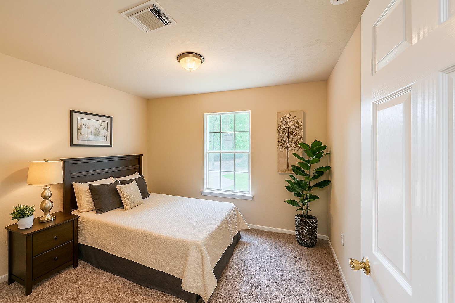 12595 Royal Springs Road Conroe, TX 77303 - Photo 25 of 26 a bedroom with a bed and a potted plant