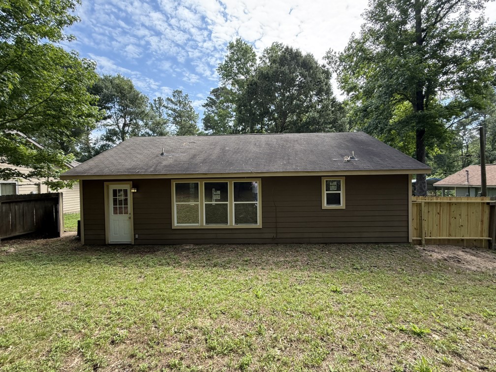 12595 Royal Springs Road Conroe, TX 77303 - Photo 4 of 26 a view of a house with a yard