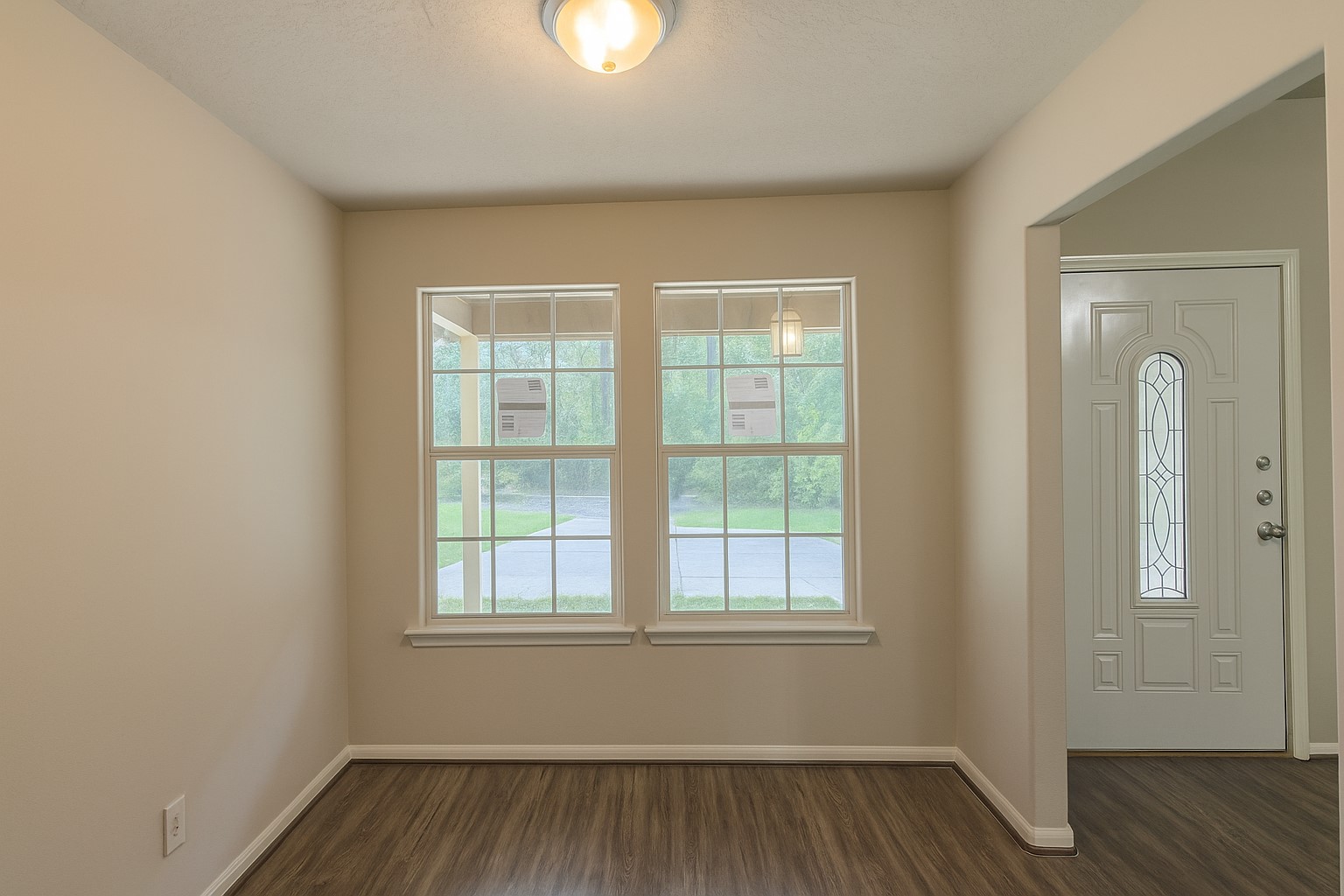 12595 Royal Springs Road Conroe, TX 77303 - Photo 8 of 26 an empty room with wooden floor and windows