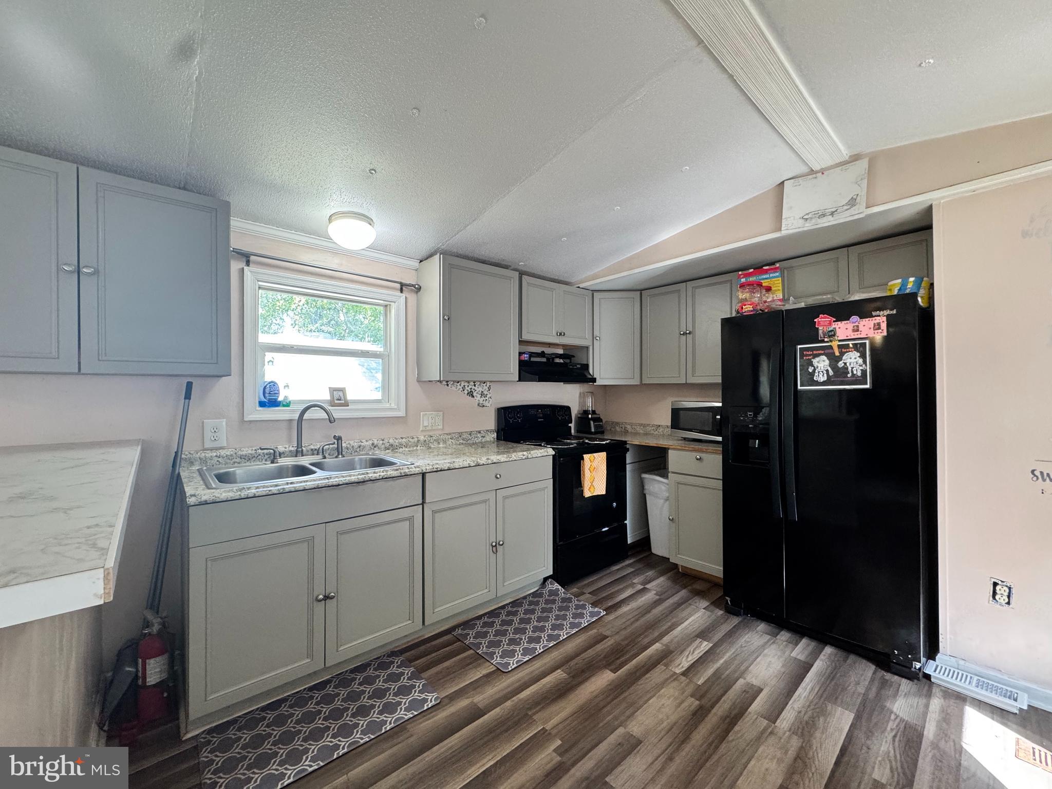 229 Sand Castle Boulevard Fruitland, MD 21826 - Photo 11 of 27 a kitchen with a sink stove and refrigerator