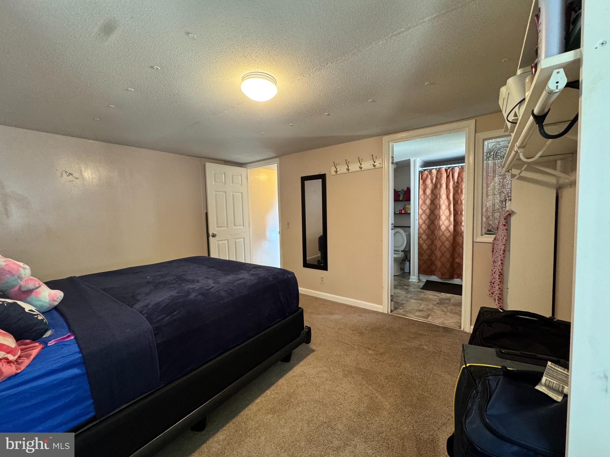 229 Sand Castle Boulevard Fruitland, MD 21826 - Photo 16 of 27 a spacious bedroom with a bed and a walk in closet