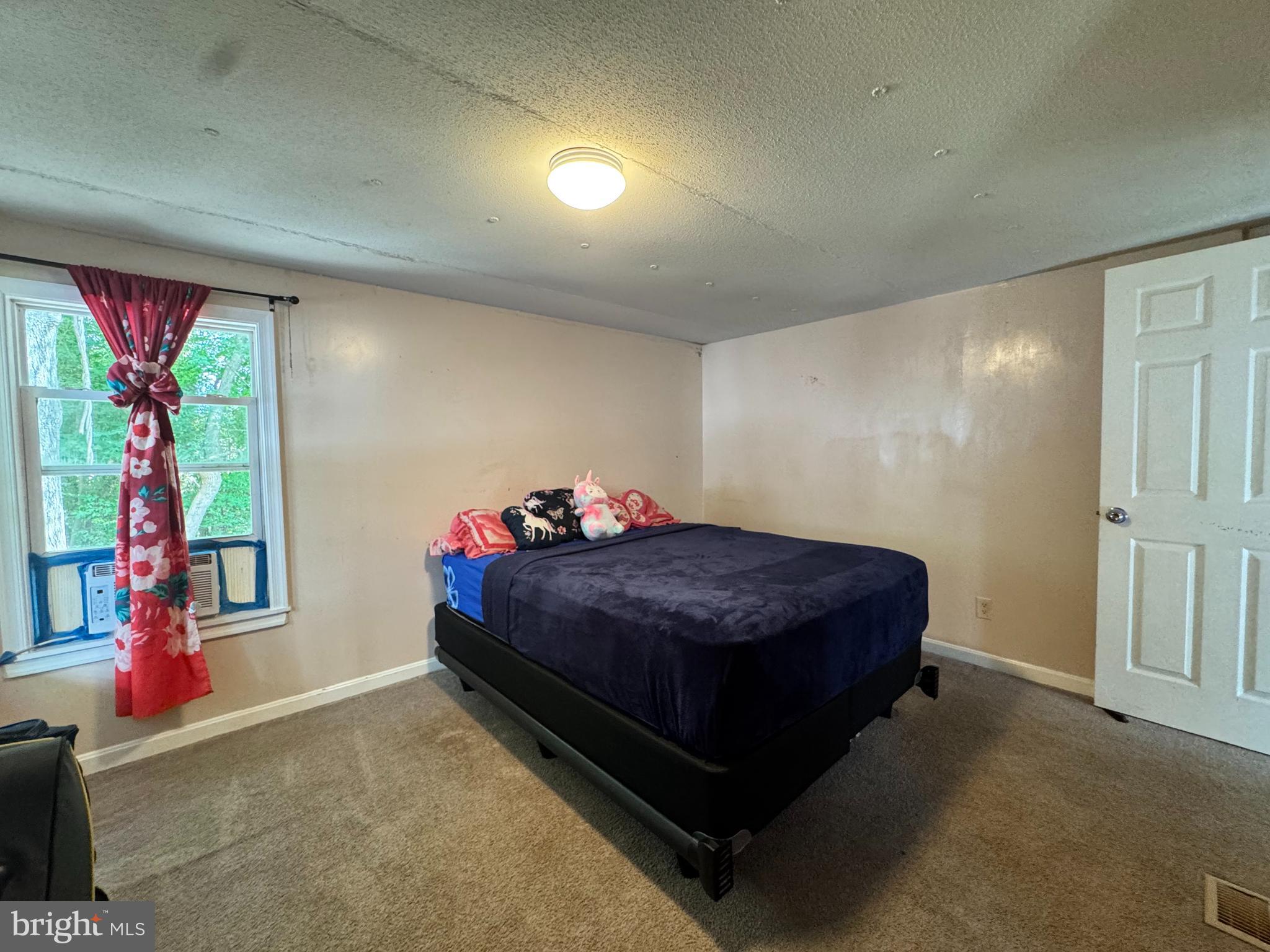 229 Sand Castle Boulevard Fruitland, MD 21826 - Photo 17 of 27 a bed sitting in a room next to a window