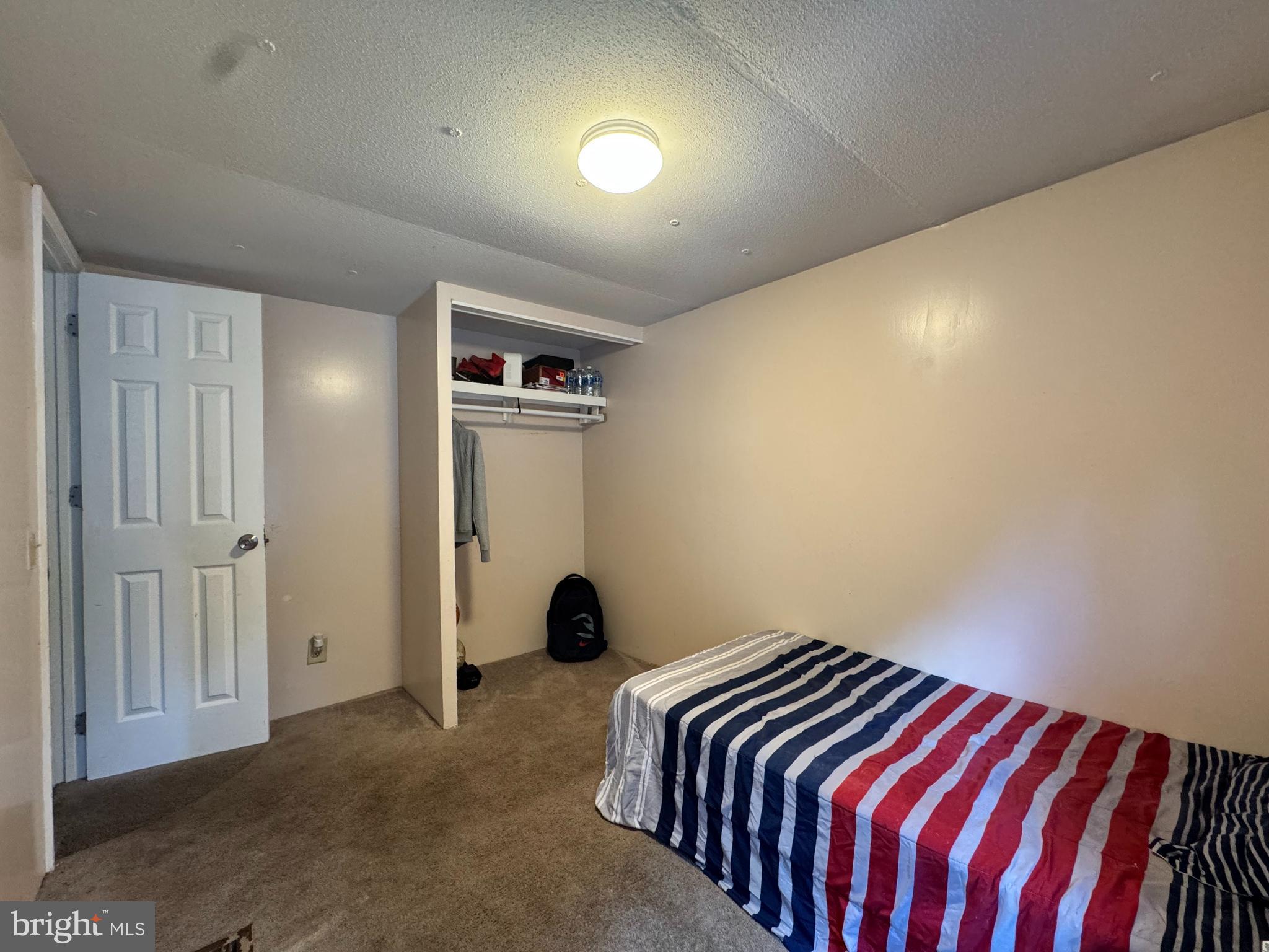 229 Sand Castle Boulevard Fruitland, MD 21826 - Photo 23 of 27 a bedroom with a bed and a book shelf