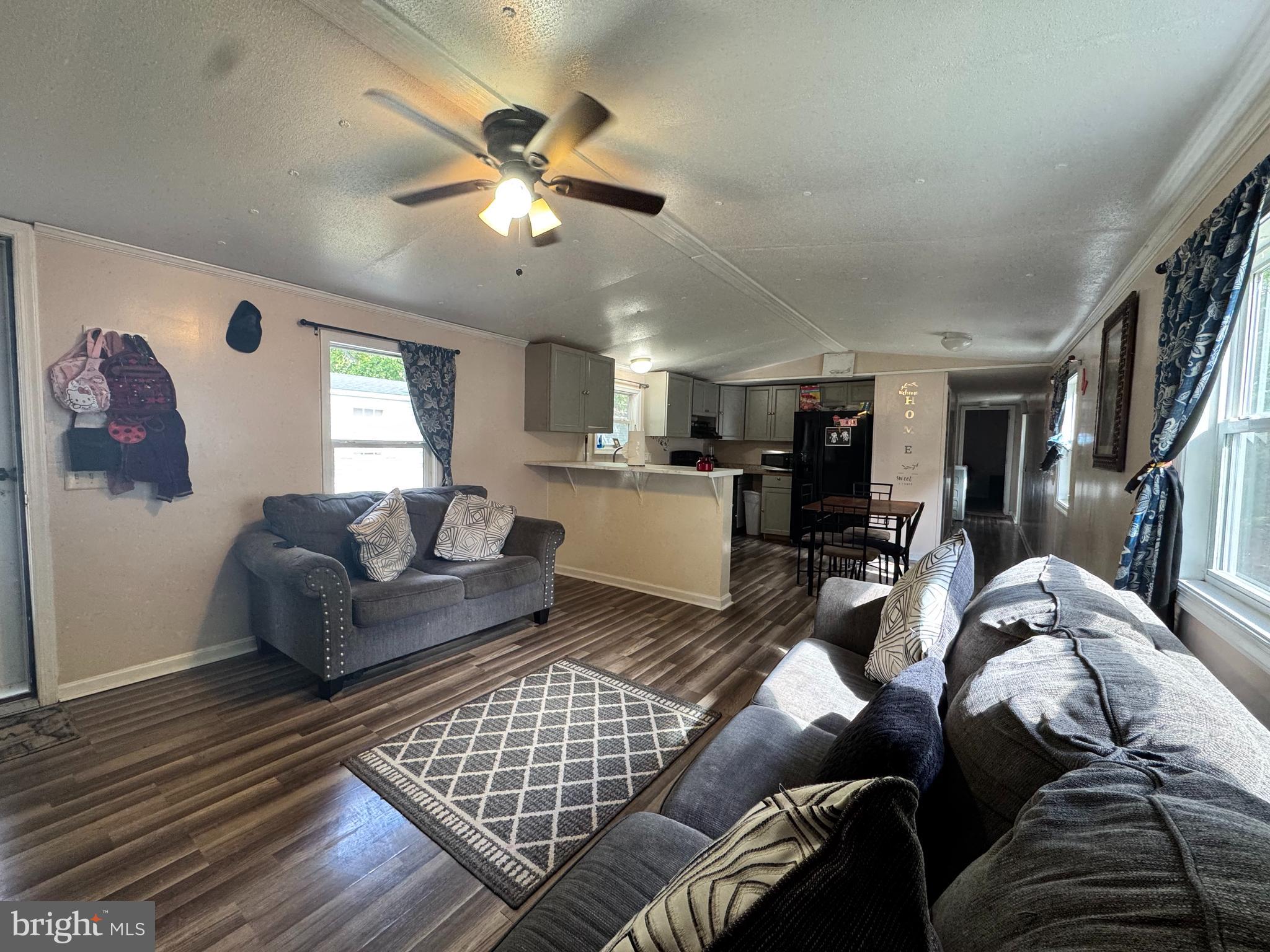 229 Sand Castle Boulevard Fruitland, MD 21826 - Photo 8 of 27 a living room with furniture kitchen view and a chandelier