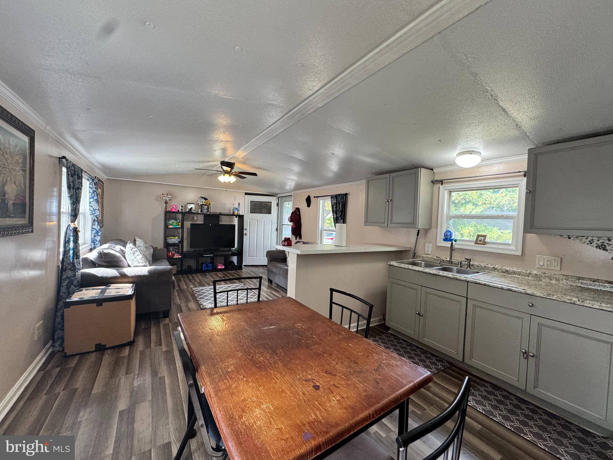 229 Sand Castle Boulevard Fruitland, MD 21826 - Photo 9 of 27 a kitchen with sink dining table and chairs