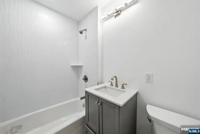 an empty room with windows and entrance