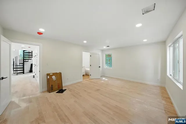 a view of a wooden house with a large window and wooden fence