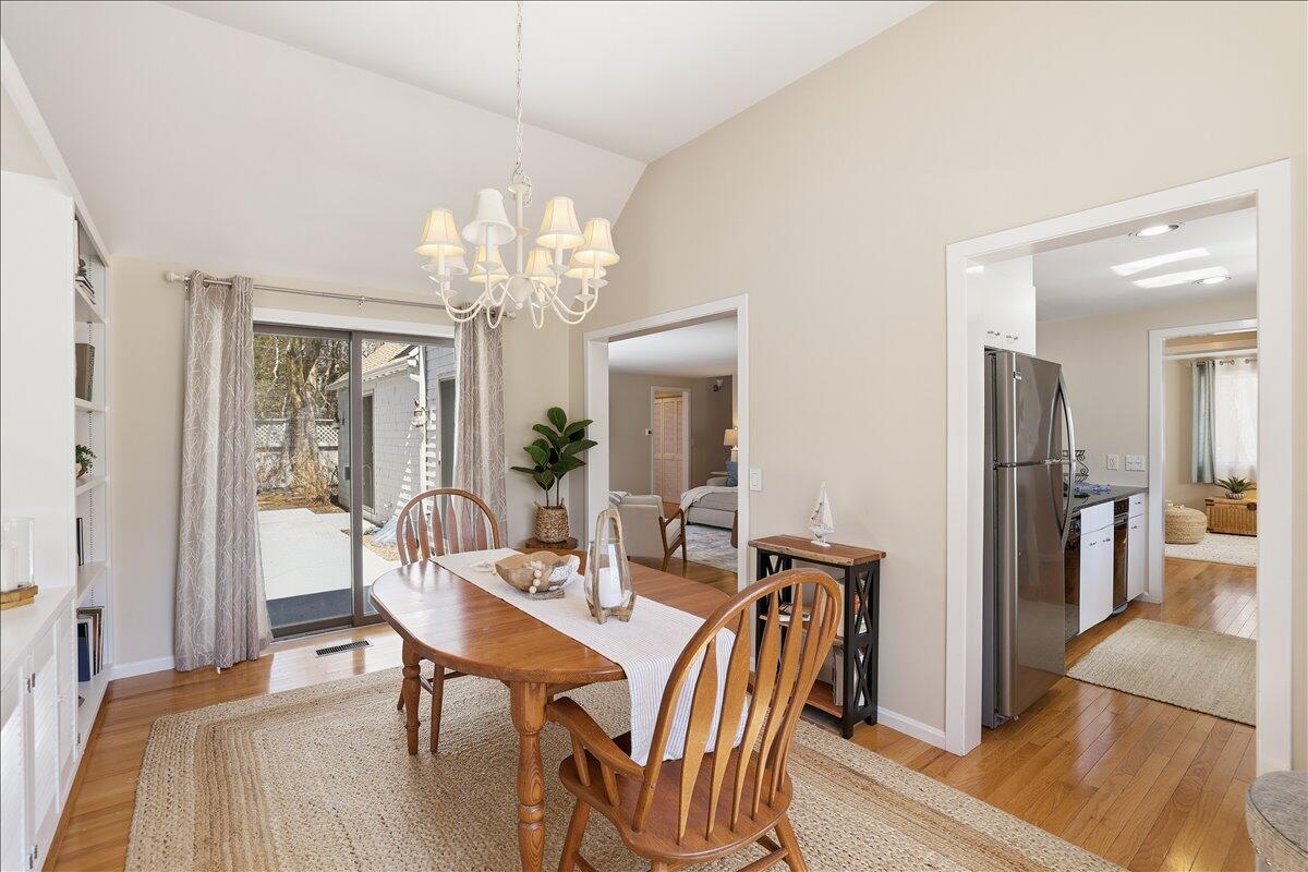 100 Mid-Iron Way, Unit 7027 Mashpee, MA 02649 - Photo 15 of 38 a view of a dining room with furniture and wooden floor