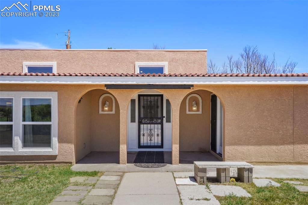 a front view of a house with a garden