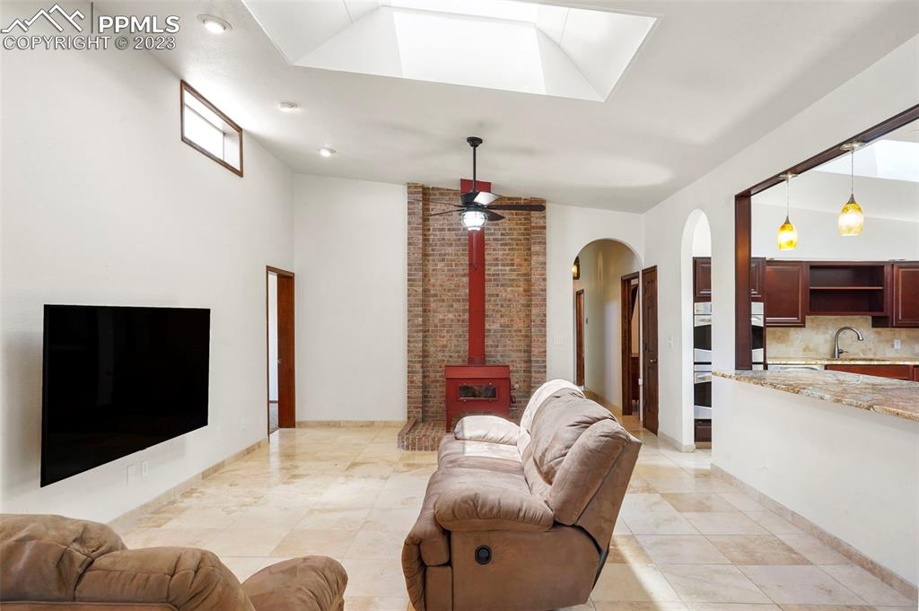 24725 Speer Road Calhan, CO 80808 - Photo 12 of 48 a living room with furniture a chandelier and a flat screen tv