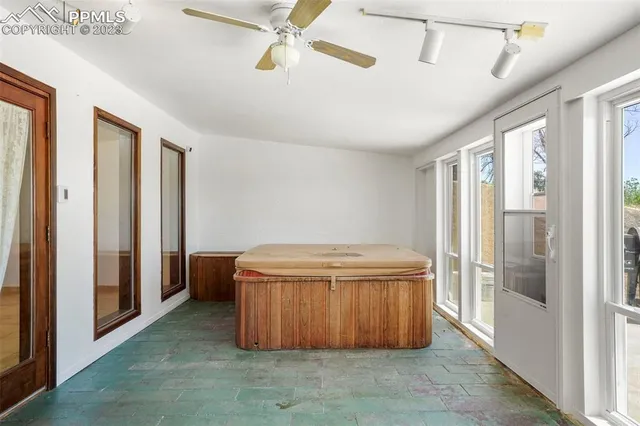 a bathroom with a tub and glass door