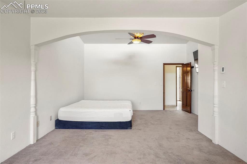 24725 Speer Road Calhan, CO 80808 - Photo 22 of 48 a bedroom with a bed and a ceiling fan