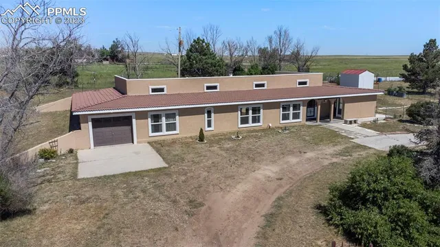 an aerial view of a house with a yard and balcony