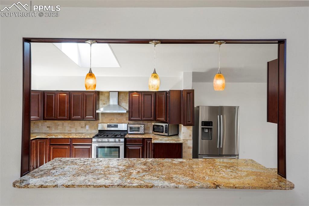 24725 Speer Road Calhan, CO 80808 - Photo 5 of 48 a kitchen with stainless steel appliances granite countertop a refrigerator and a stove top oven