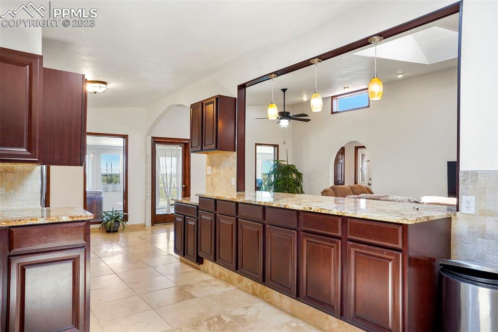 24725 Speer Road Calhan, CO 80808 - Photo 8 of 48 a spacious bathroom with a granite countertop sink a mirror and shower