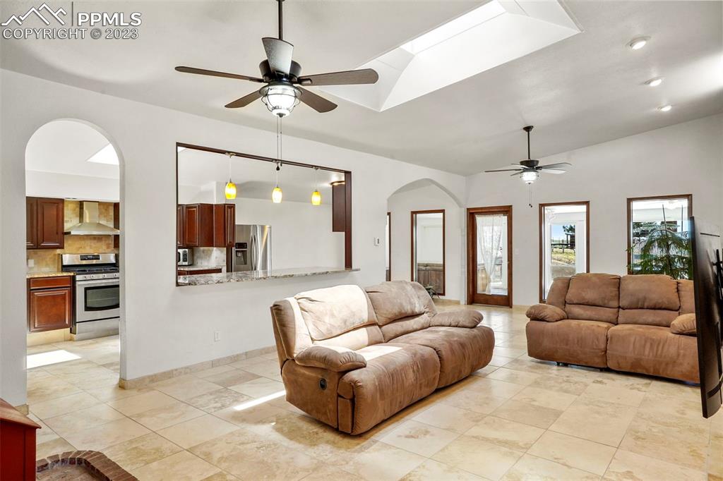 24725 Speer Road Calhan, CO 80808 - Photo 9 of 48 a living room with furniture ceiling fan and a rug