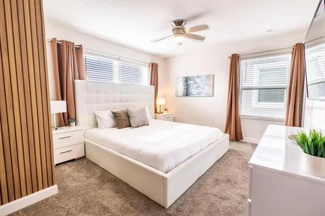 a bedroom with a large bed and a chandelier