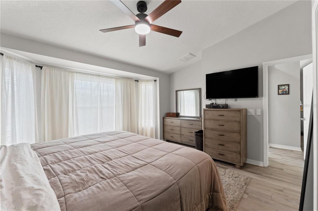 12310 Boot Spur Way Spring Hill, FL 34610 - Photo 15 of 36 a bedroom with a bed and a flat screen tv