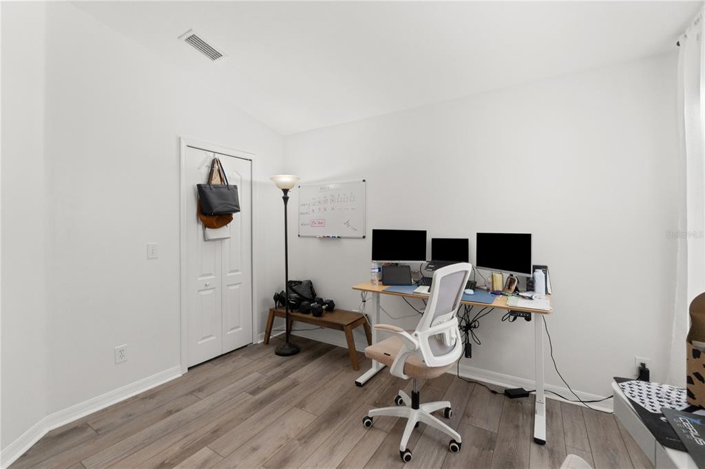 12310 Boot Spur Way Spring Hill, FL 34610 - Photo 21 of 36 a view of a workspace with furniture and wooden floor