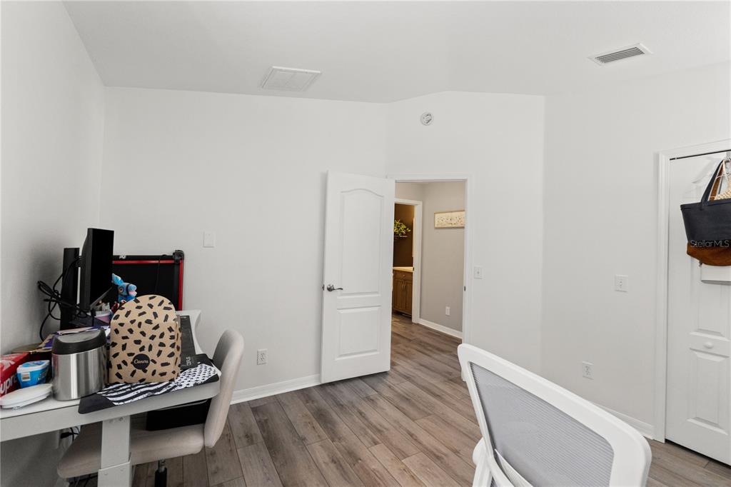 12310 Boot Spur Way Spring Hill, FL 34610 - Photo 22 of 36 a room with furniture and wooden floor